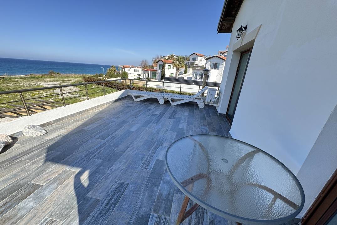 The villa is located in a complex that is located next to a beautiful bay